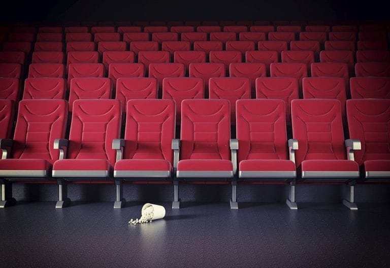 Cinema interior illustration with red seating and popcorn on a dark floor