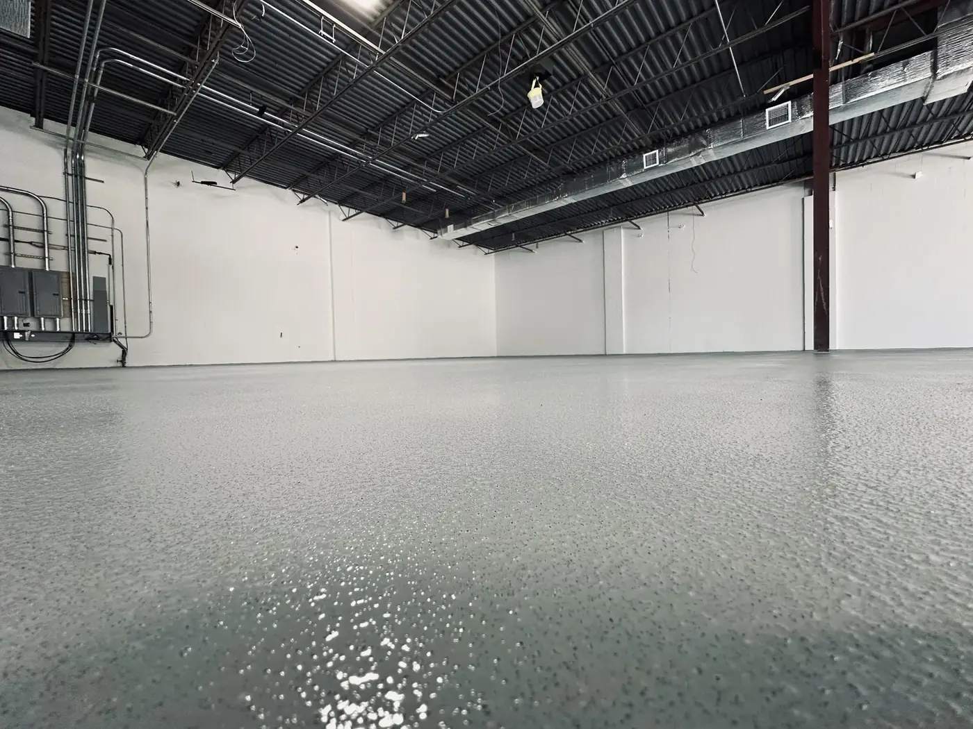 Textured light-grey epoxy floor in a commercial warehouse space in Vancouver, BC