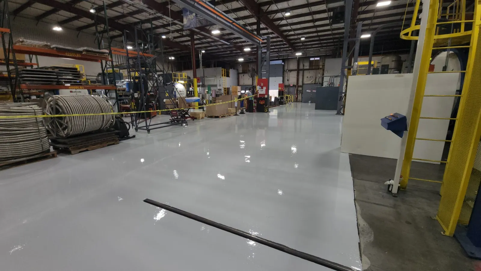 Gray industrial epoxy floor coating in manufacturing facility