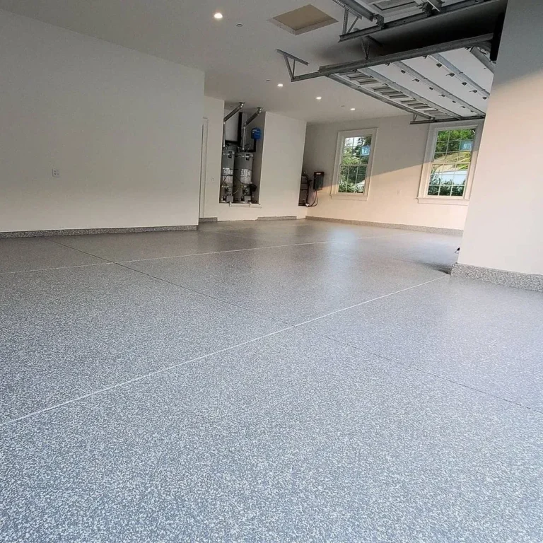 Grey flake garage floor with visible joints and light-coloured walls.