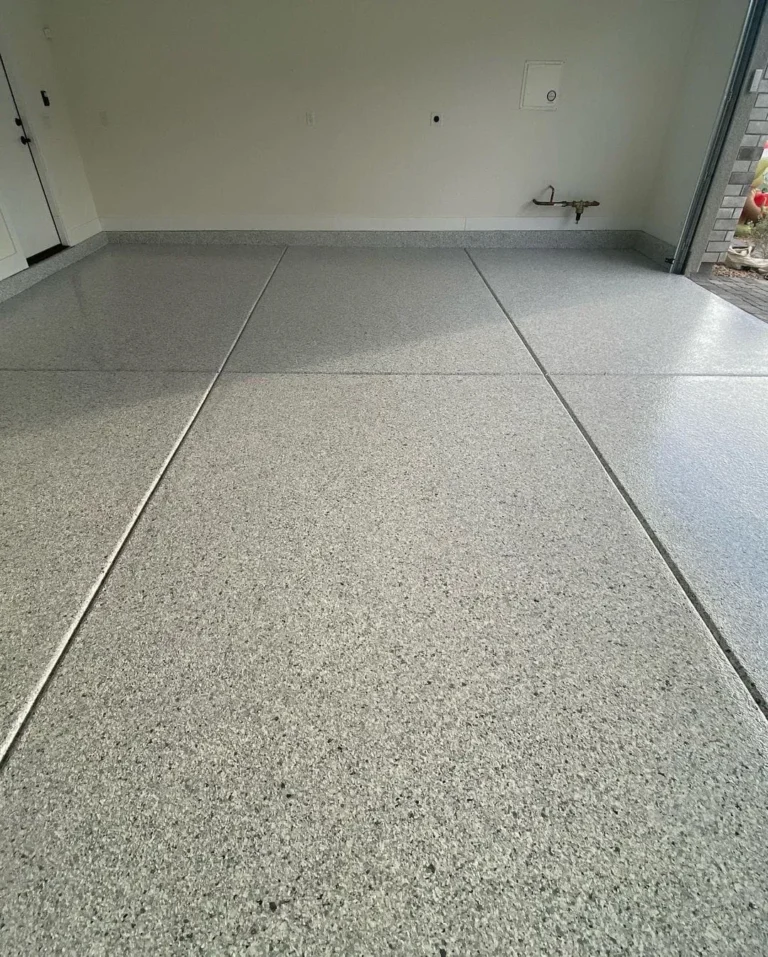 Light grey flake garage finish with joint lines and daylight at the entrance.