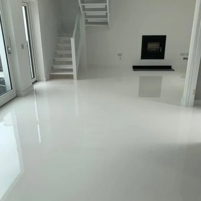 White glossy floor in a modern home with a staircase and wall-mounted fireplace.
