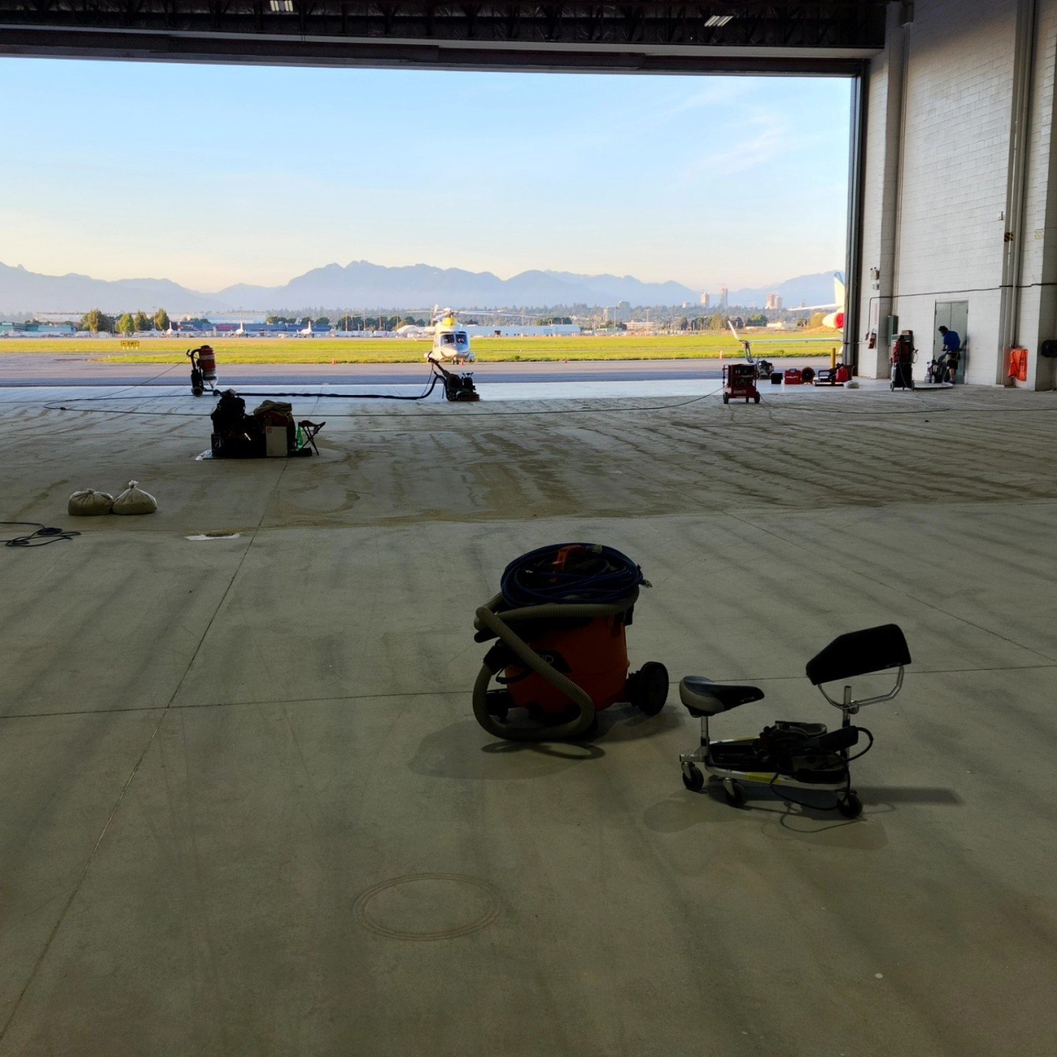 Aircraft hangar concrete floor preparation before resin coating at YVR