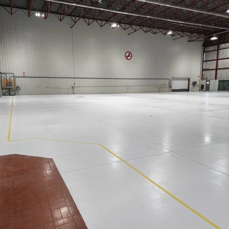 Yellow line marking across the light-grey coated floor at Million Air, YVR