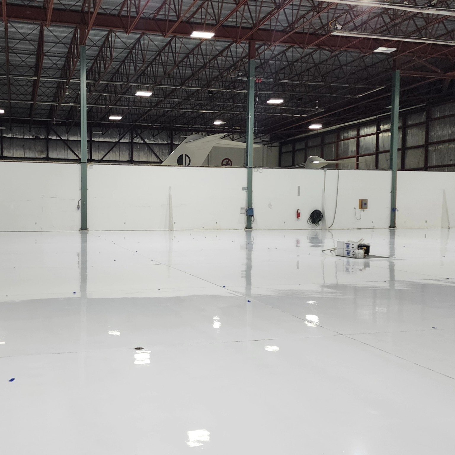 Completed aircraft hangar resin floor with aircraft visible at YVR Airport
