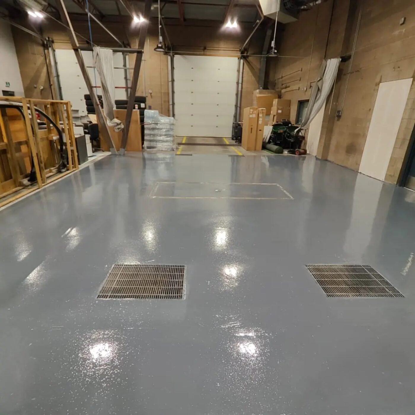 Grey resin floor installed in the service area at Brian Jessel BMW in Burnaby
