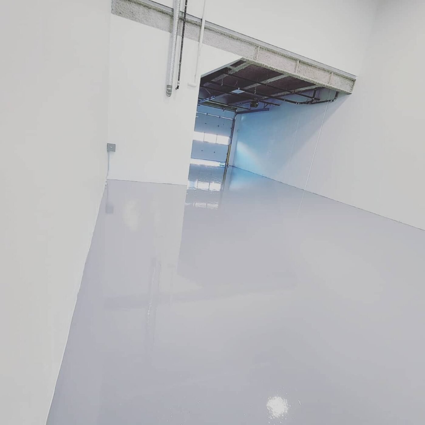Smooth grey commercial resin floor installed by Priority One in Burnaby BC