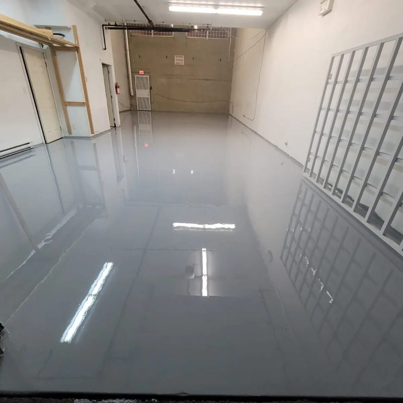 Completed solid-grey commercial floor coating in a Burnaby BC unit