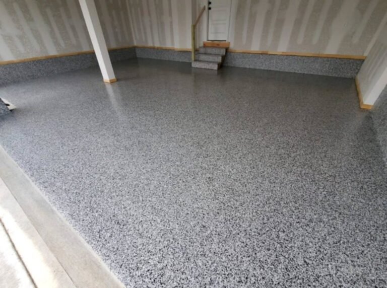 Grey full-flake floor with coated steps and textured perimeter details