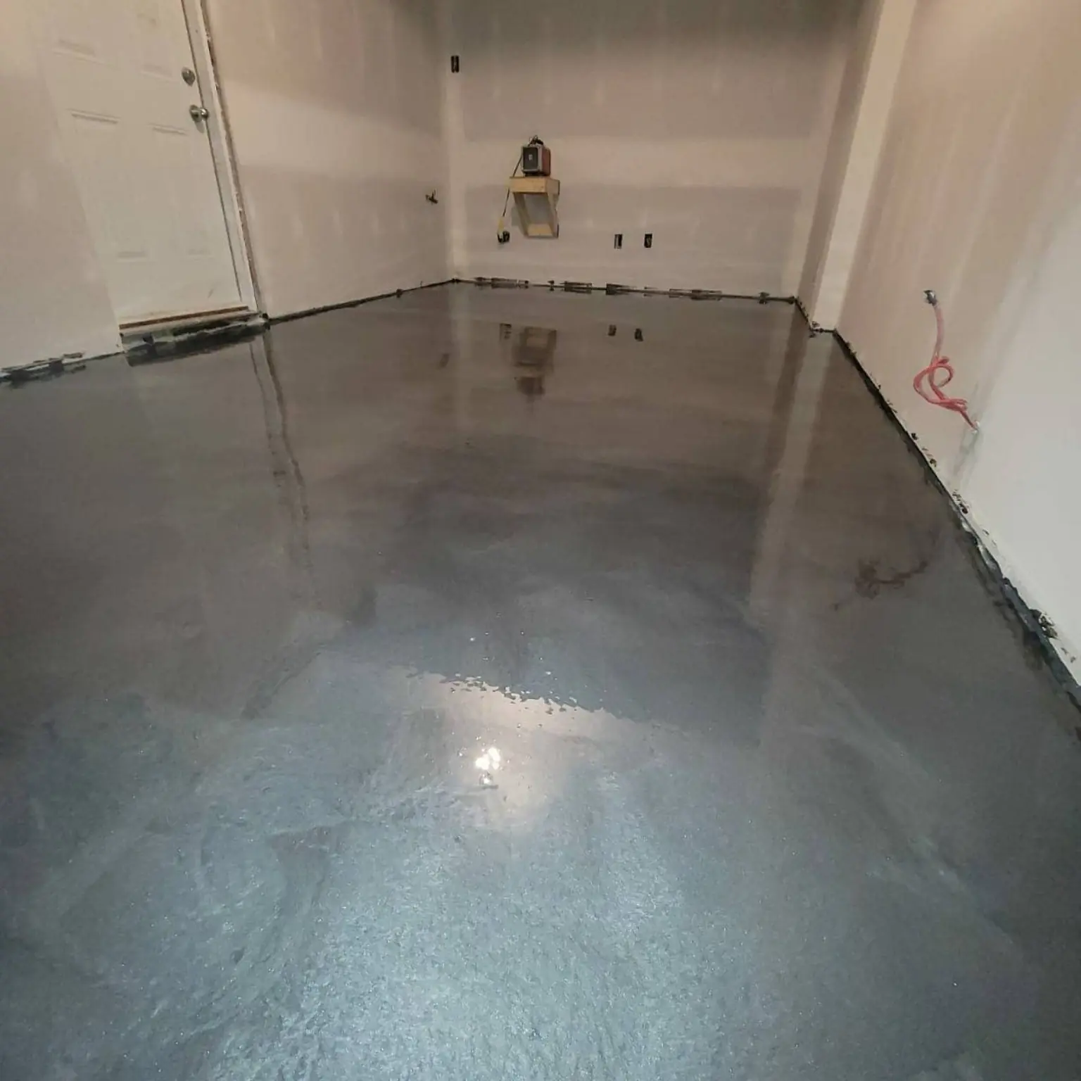 Glossy grey epoxy floor in a residential garage