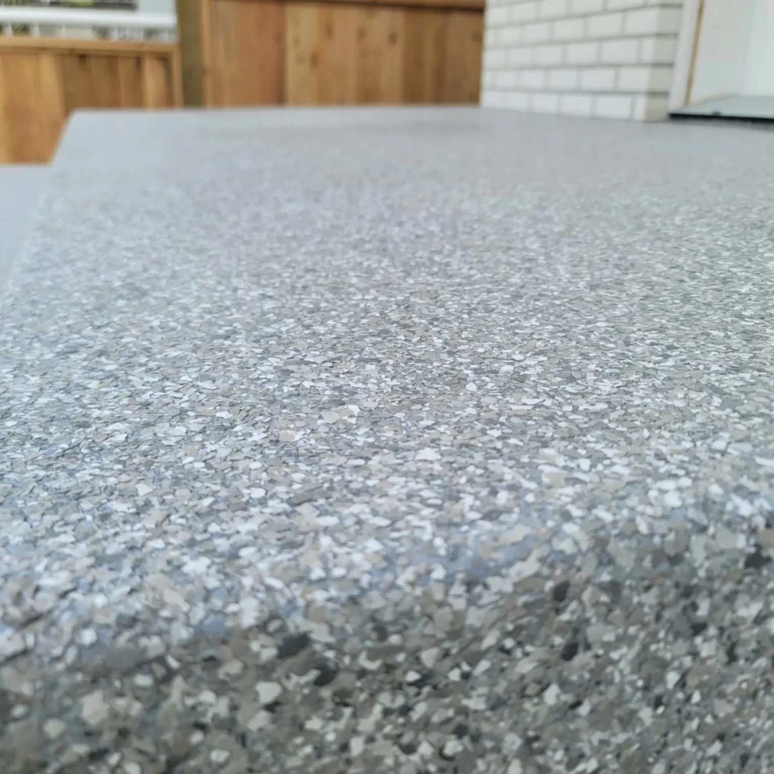 Close-up of a decorative flake resin surface and finished edge