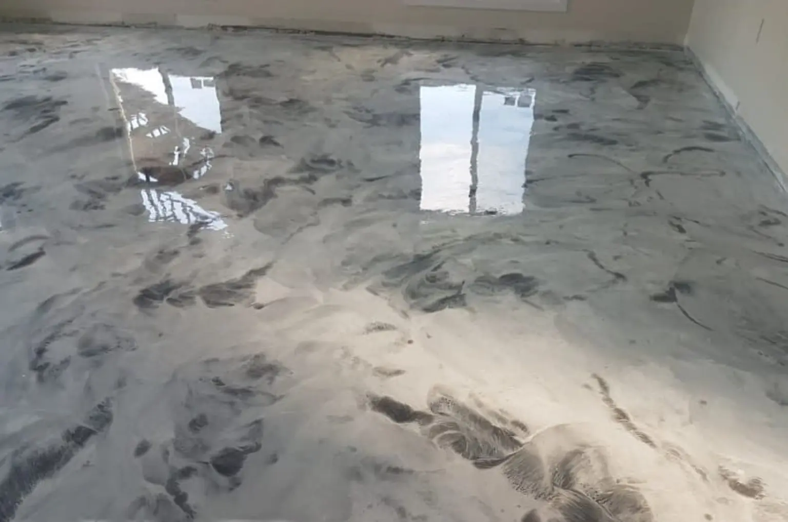 White, grey and black marble-look metallic epoxy floor completed by Priority One