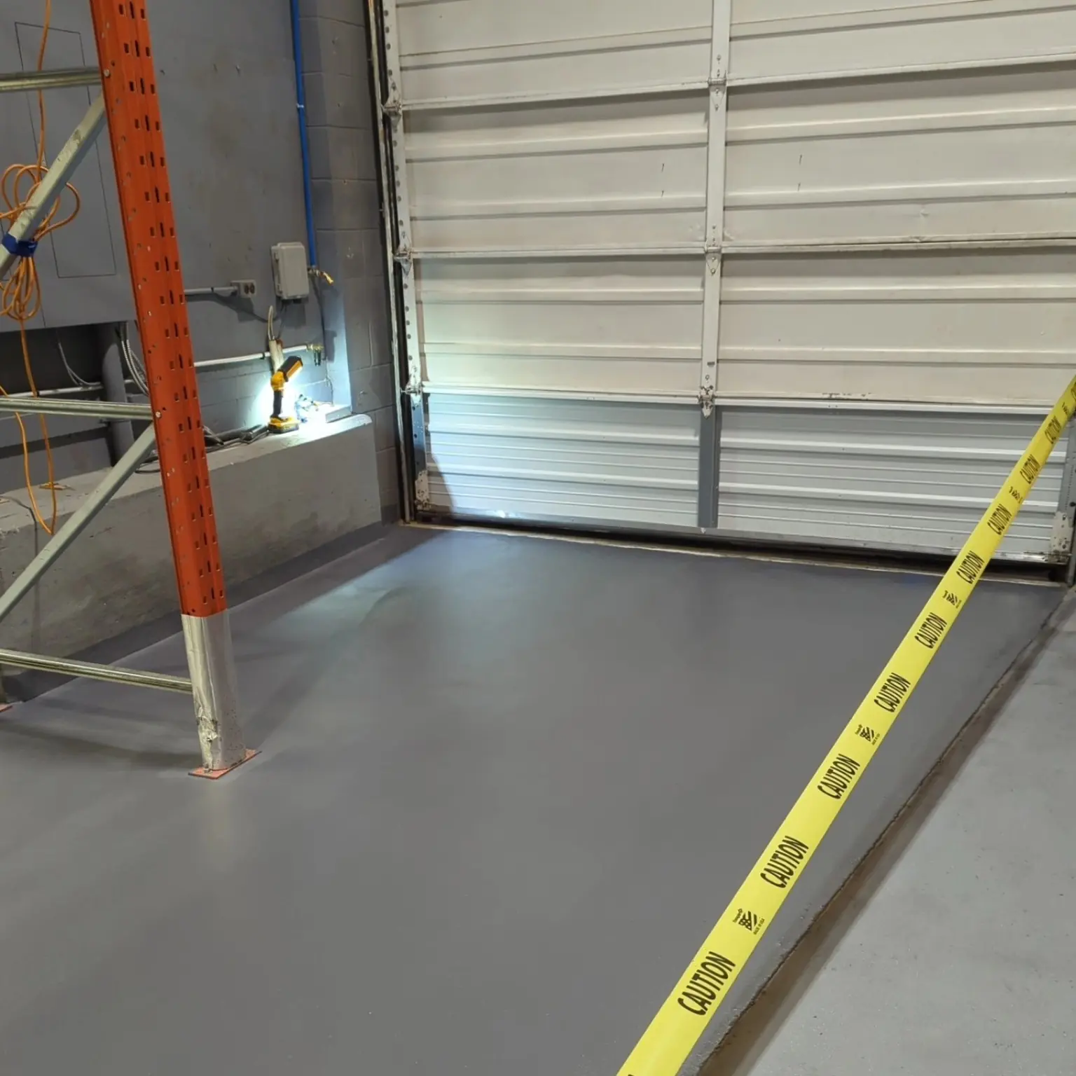 Urethane cement floor at a loading-door threshold installed by Priority One in Marpole Vancouver