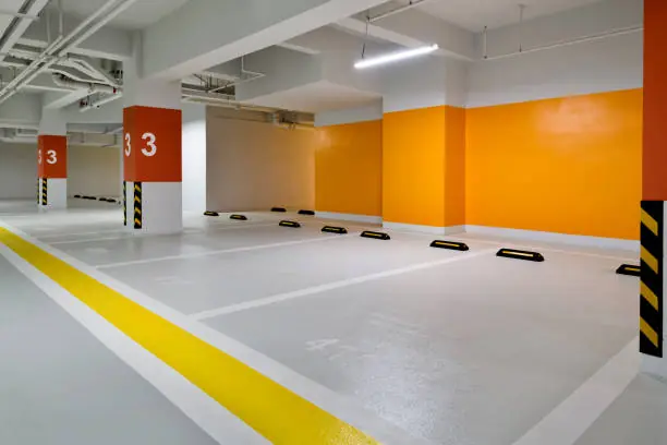 Waterproof parking garage coating with marked parking stalls