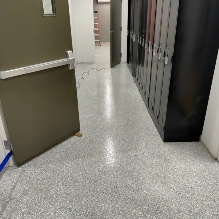 Grey flake resin flooring beside staff lockers at the Liebherr facility in Abbotsford