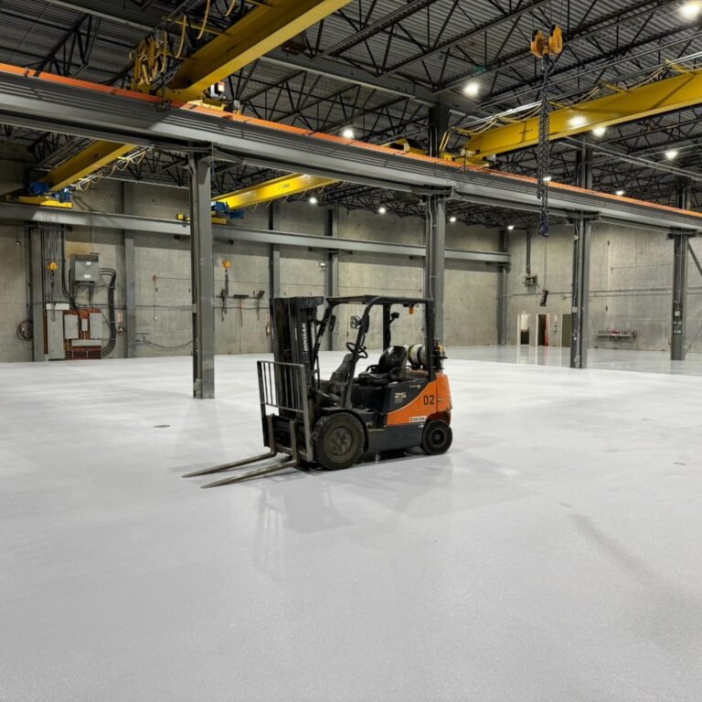 Forklift on completed Priority One industrial warehouse flooring at Liebherr in Abbotsford, BC