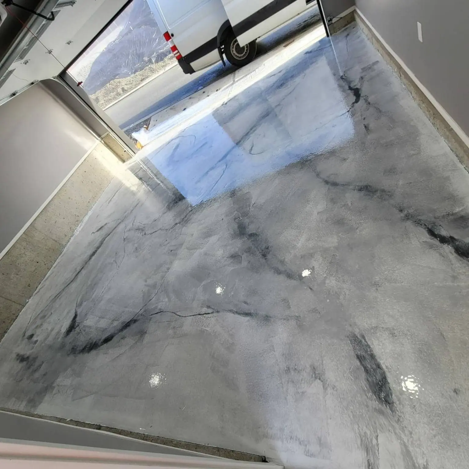 Silver and black marble-look metallic epoxy garage floor