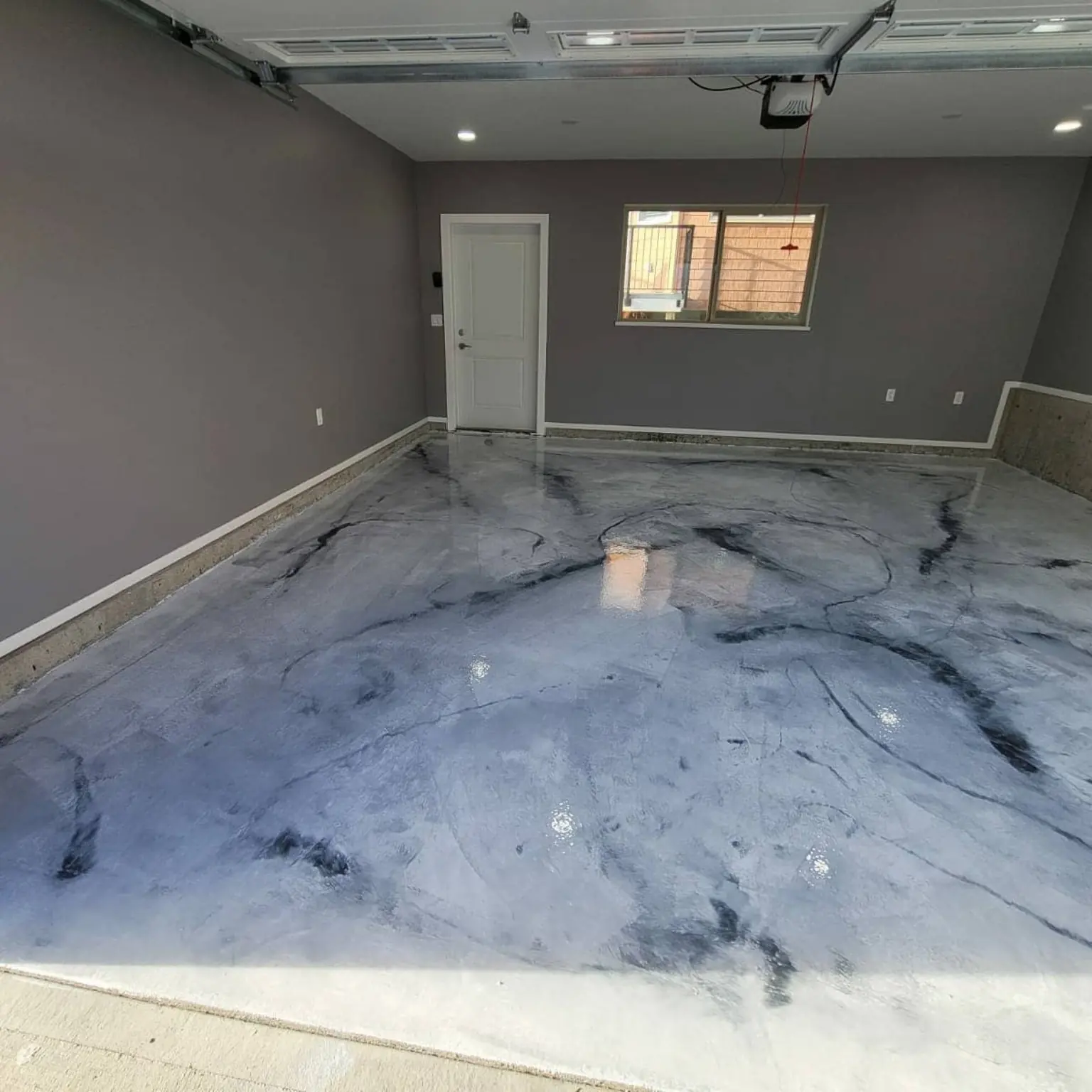 Silver and charcoal metallic epoxy garage floor with marble movement