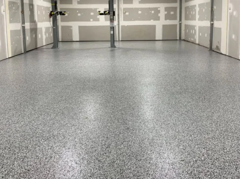 Decorative flake garage flooring around vehicle-lift posts in South Granville