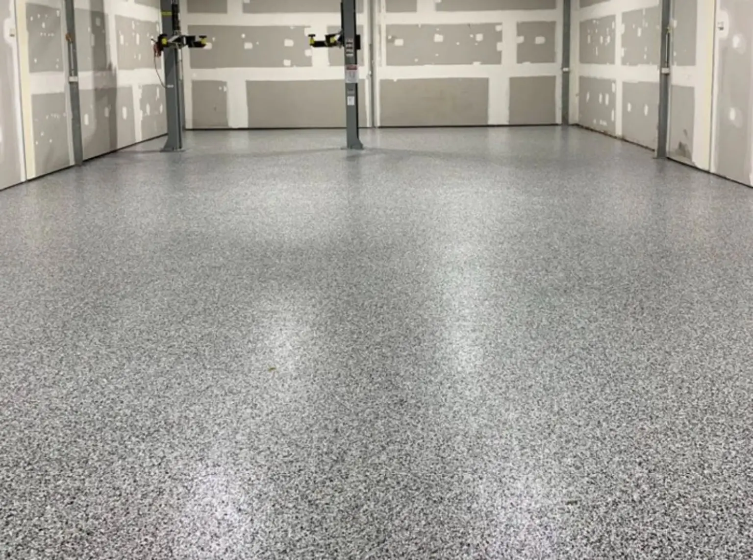 Full-flake epoxy garage floor with vehicle lifts in South Granville