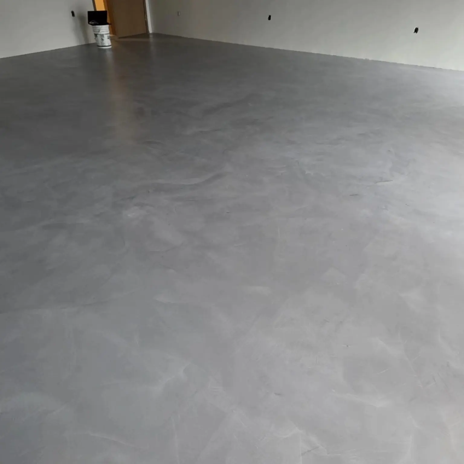 Completed solid-colour grey epoxy floor in a Strathcona interior