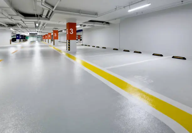 Traffic deck coating across an underground parkade drive aisle