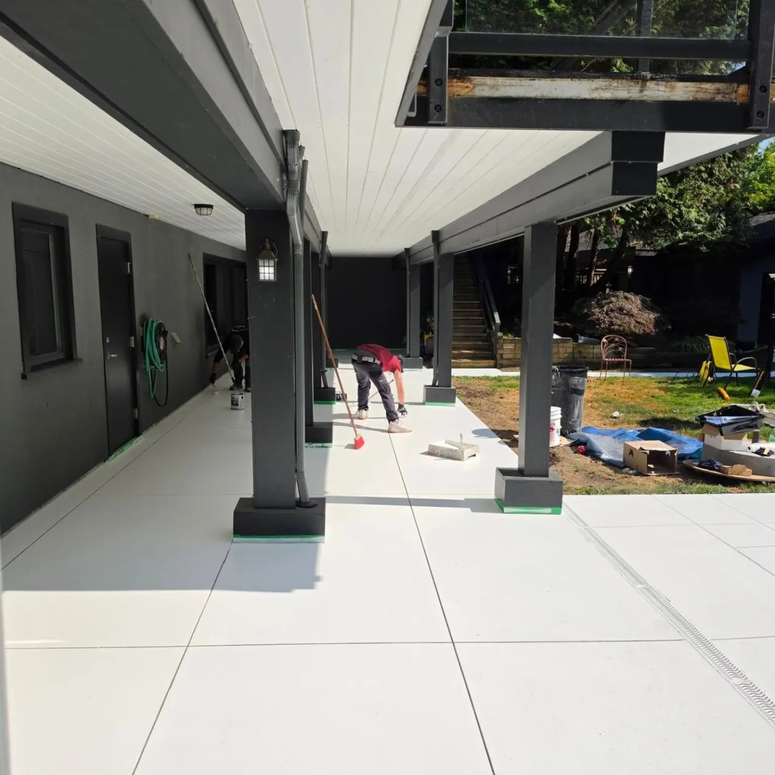 Solid-colour resin walkway coating being installed near UBC and UEL