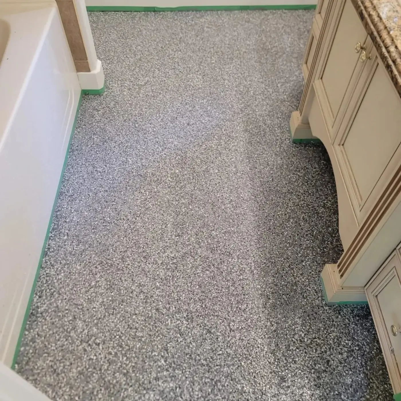 Full-flake epoxy floor installed in a West Vancouver residential bathroom and utility area